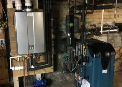A room equipped with a water heater, furnace, and other machinery, showcasing a functional utility space.